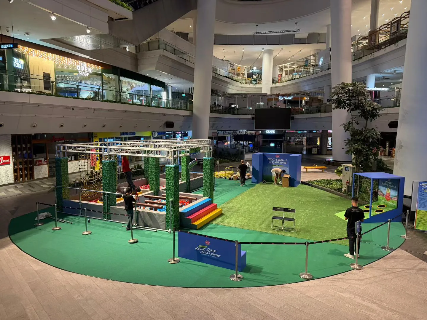 Ground view of Kick Off Challenge activation setup with football fencing and bowling props