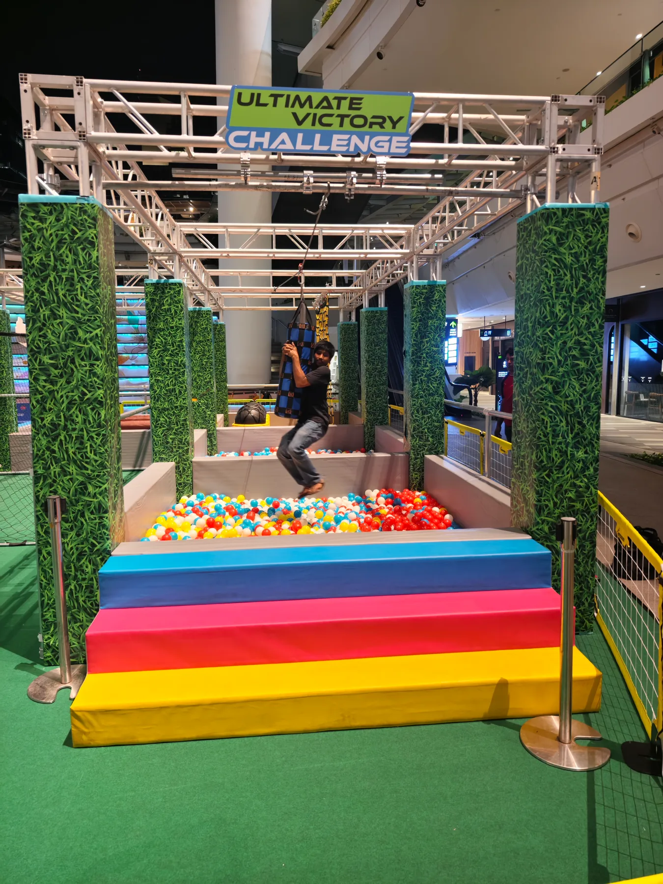 Football bowling lane with truss frame and colorful balls