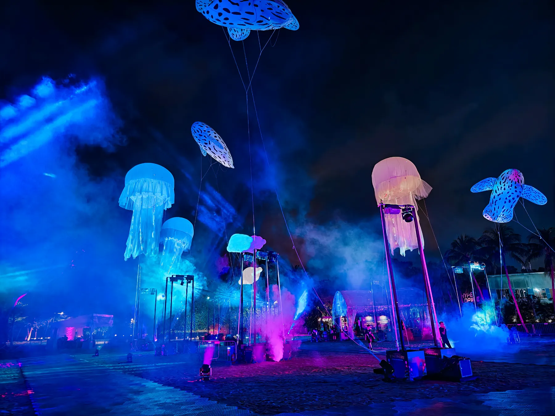 Blue stage lighting around floating inflatable structures