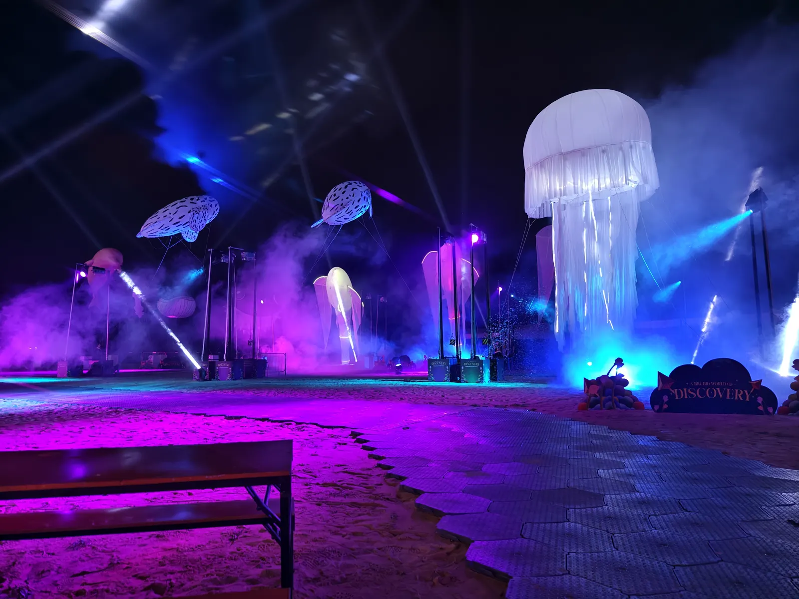 A BIG BIG WORLD stage atmosphere with lights and floating forms