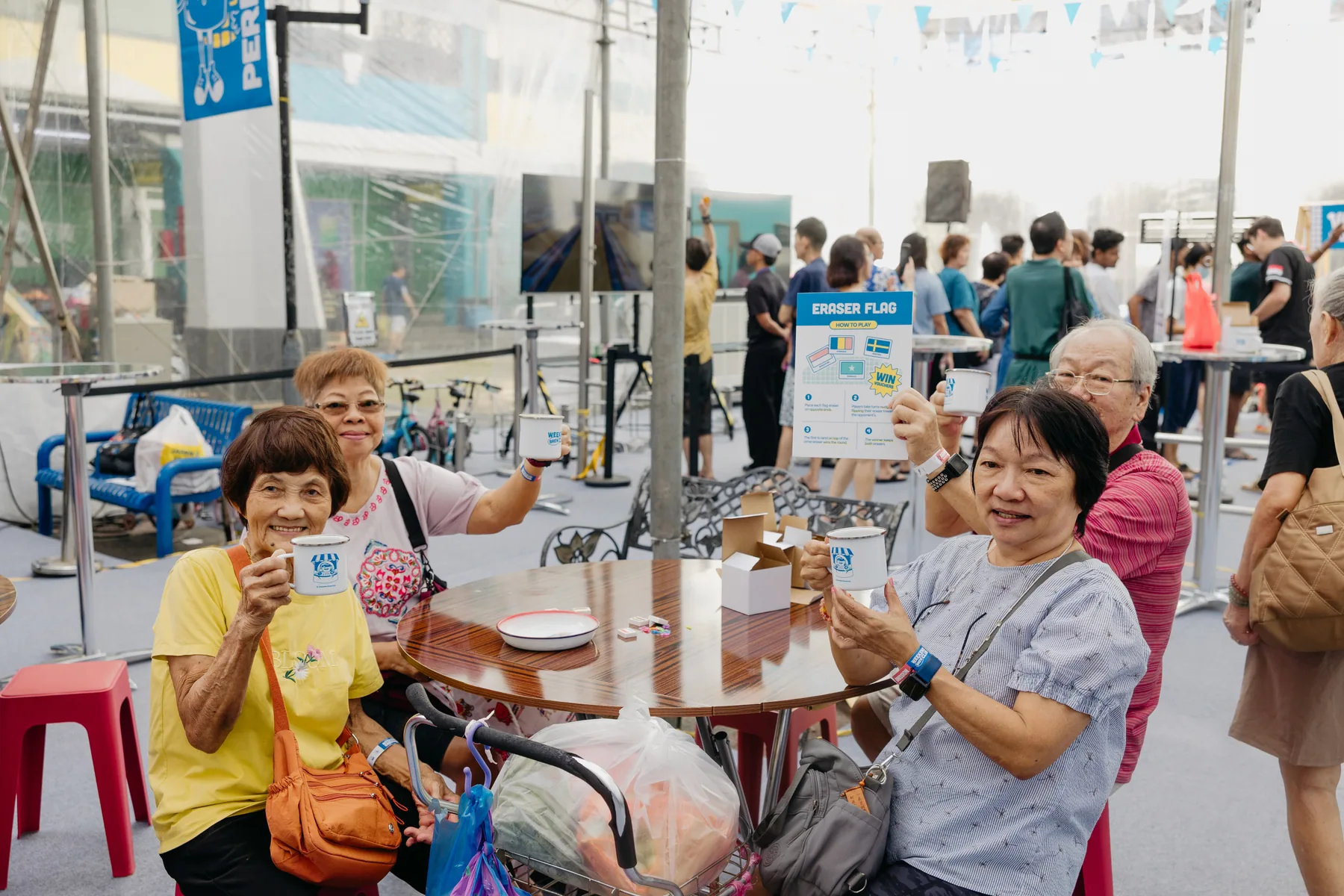 Community group holding Weekend Brew Club mugs while taking part in an event game