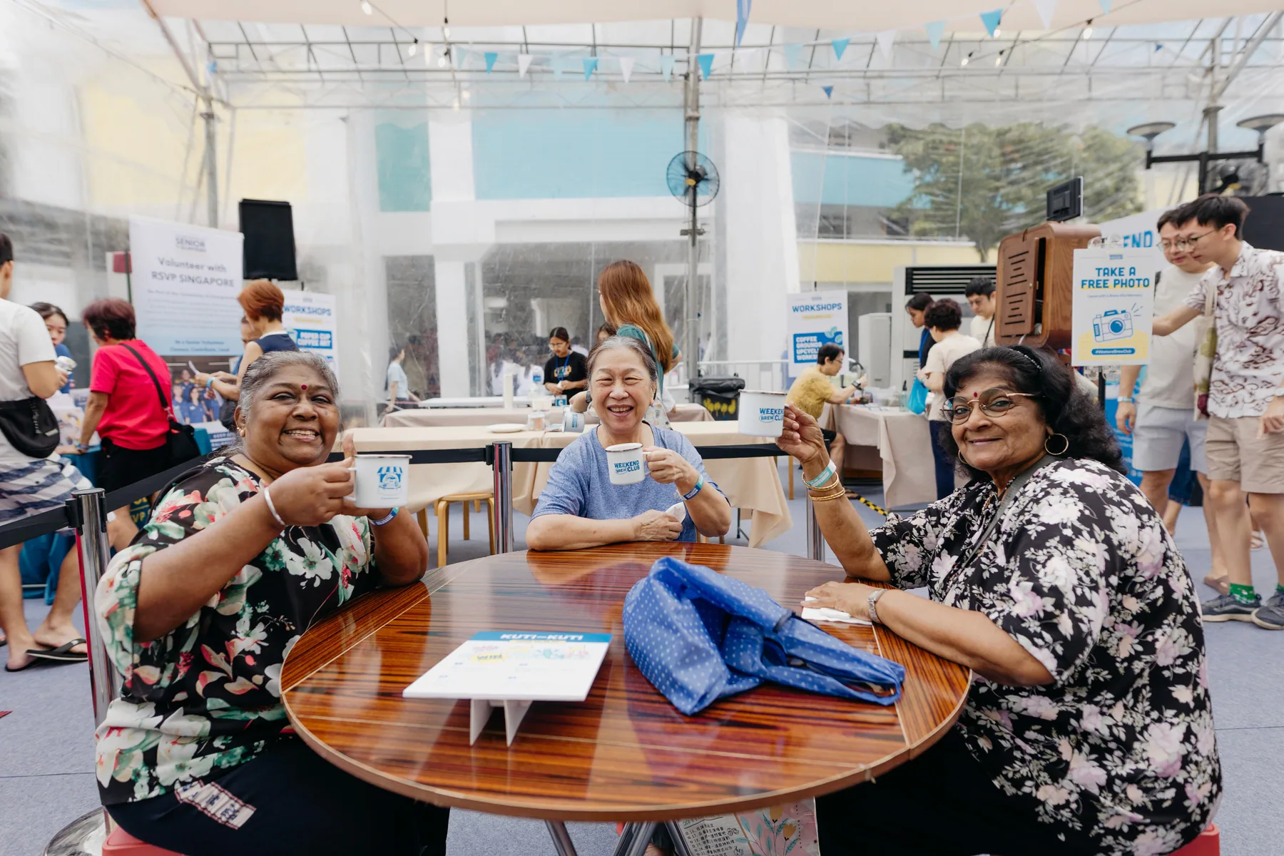 Weekend Brew Club attendees raising custom enamel mugs at the community event