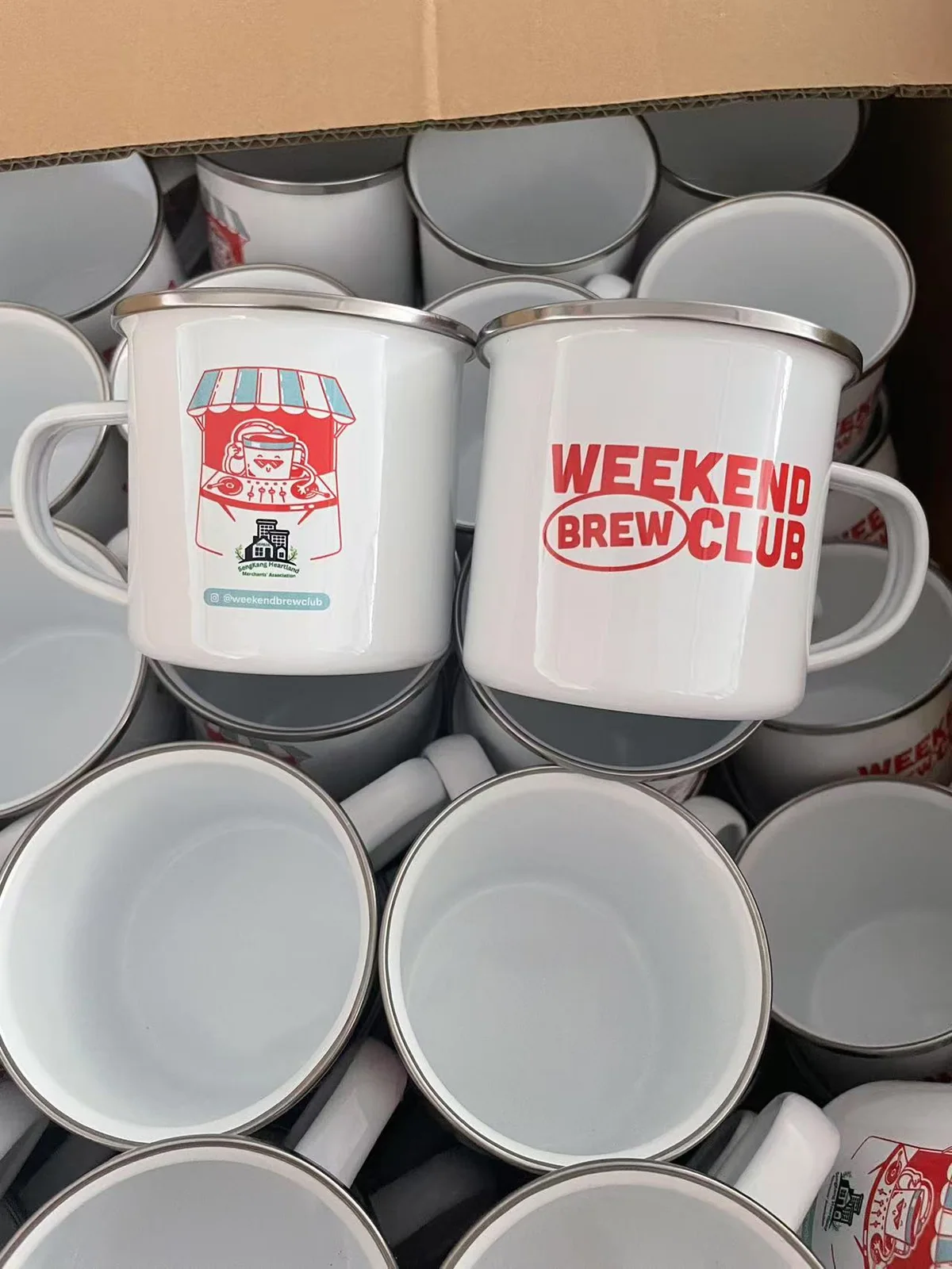 Bulk Sengkang Weekend Brew Club mugs arranged in a production carton