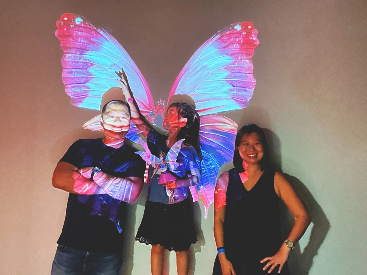 Visitor using the butterfly projection selfie wall
